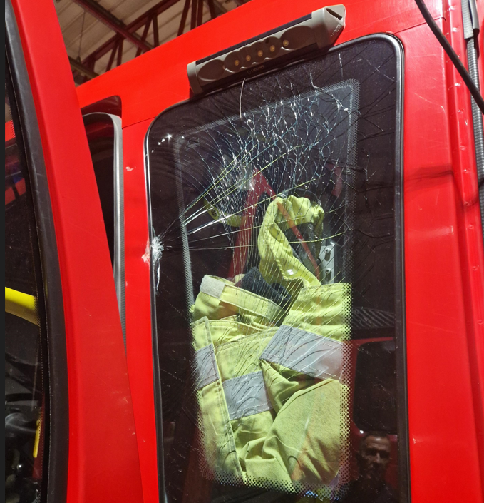 Window of fire engine smashed during an attack