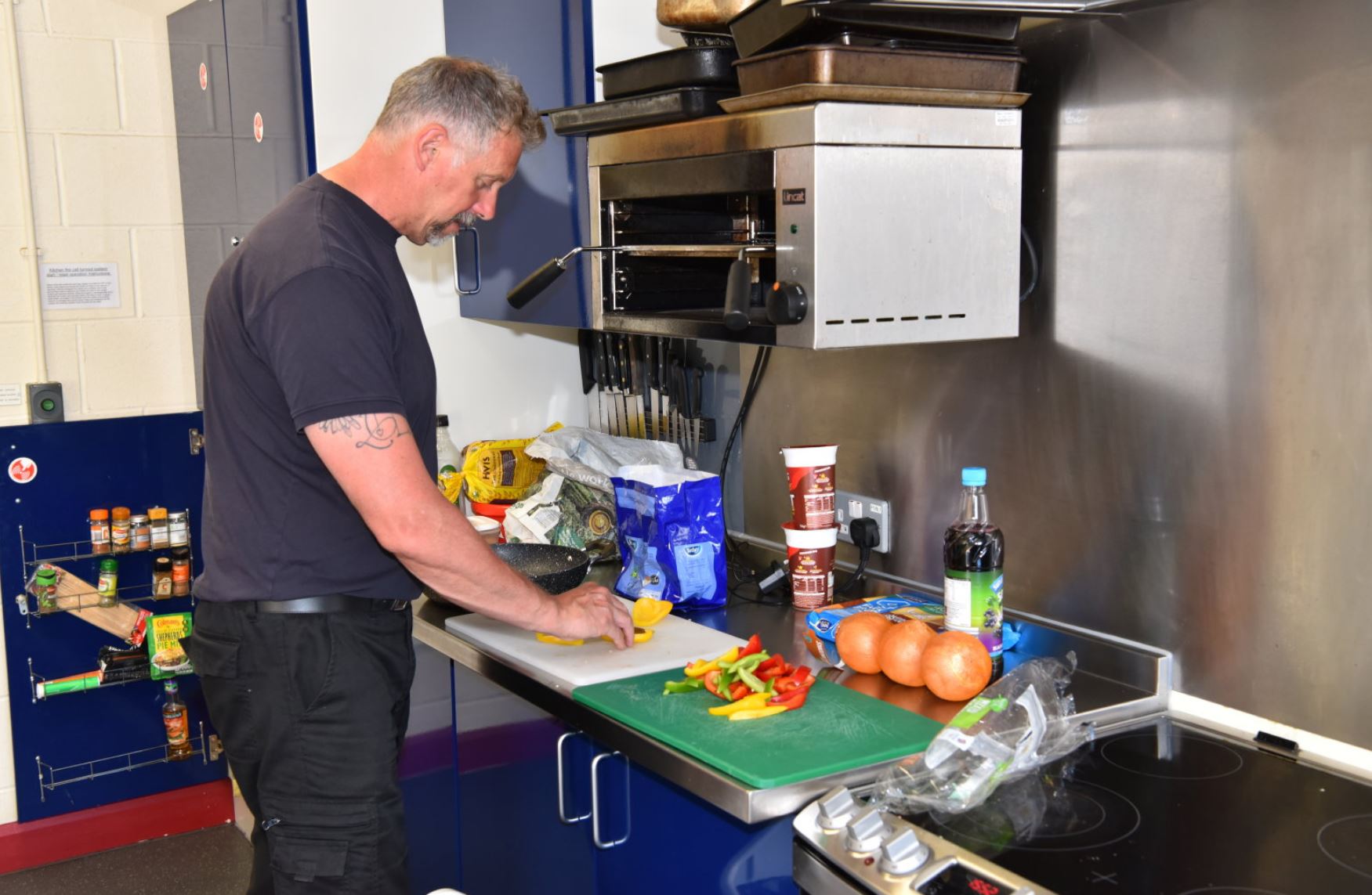 Firefighter in the kitchen preparing a meal.