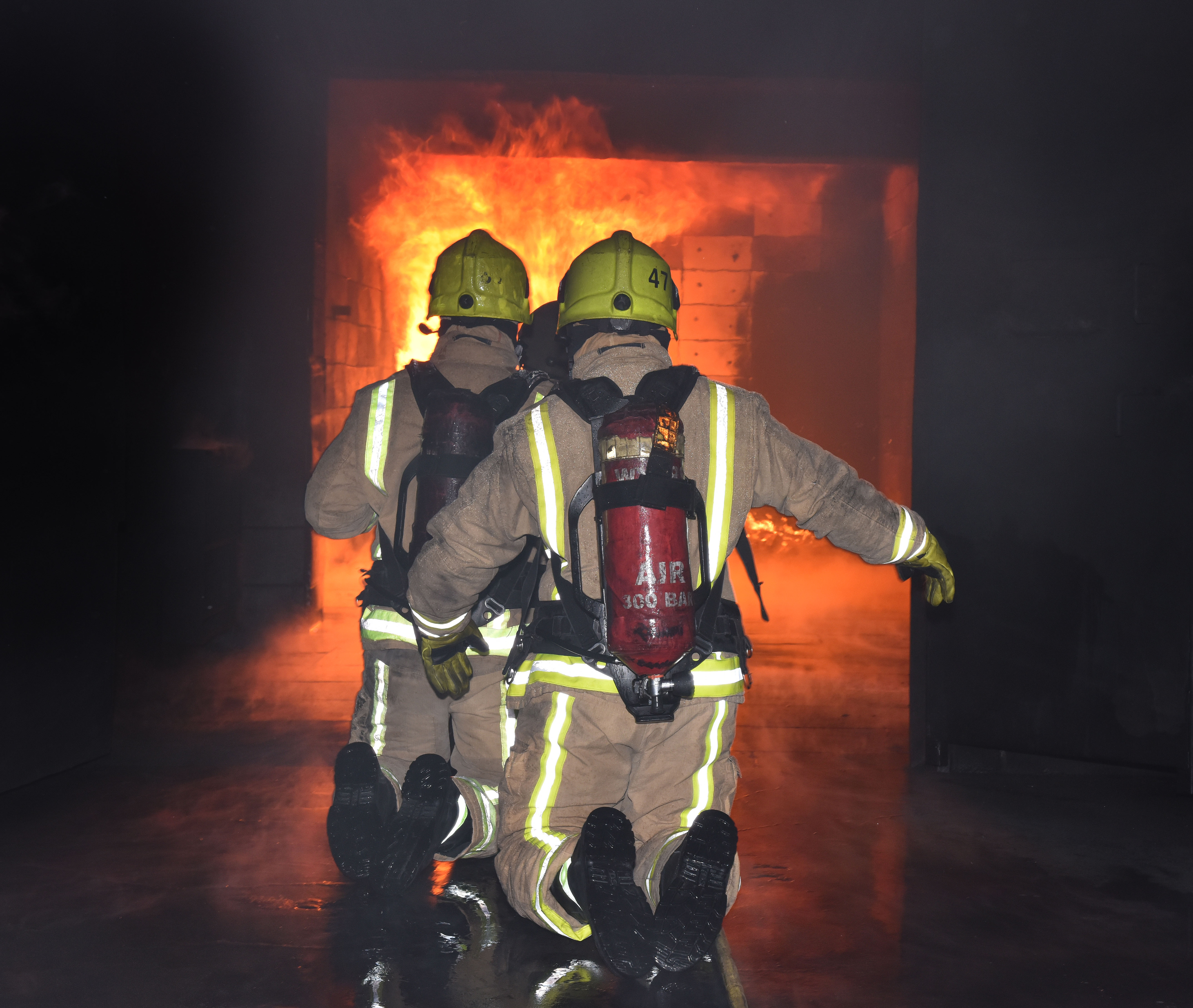 Firefighters tackling a fire in a container. 