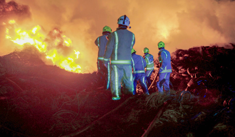 Firefighters tackling large fire.