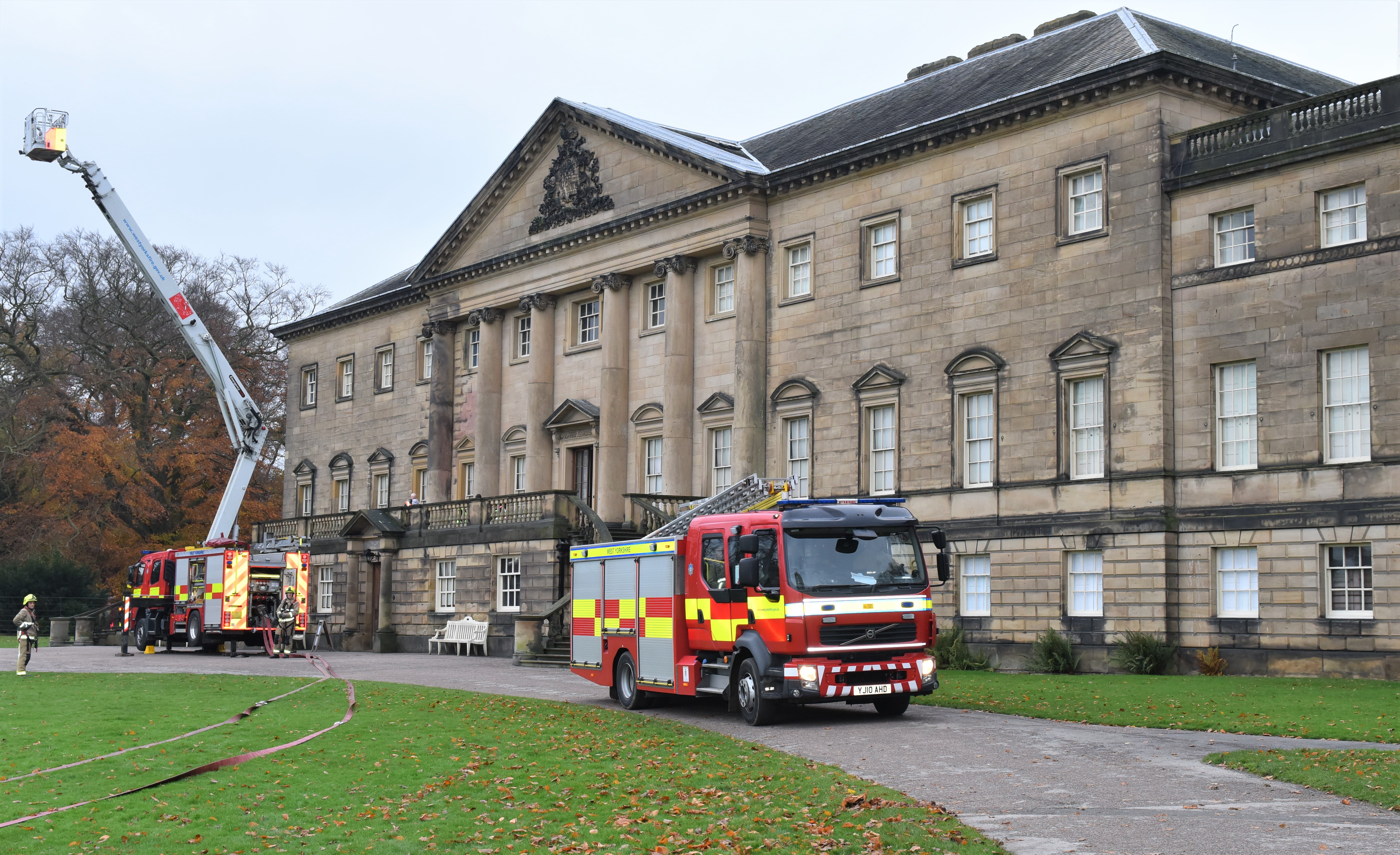 Fire engines in front of large building.