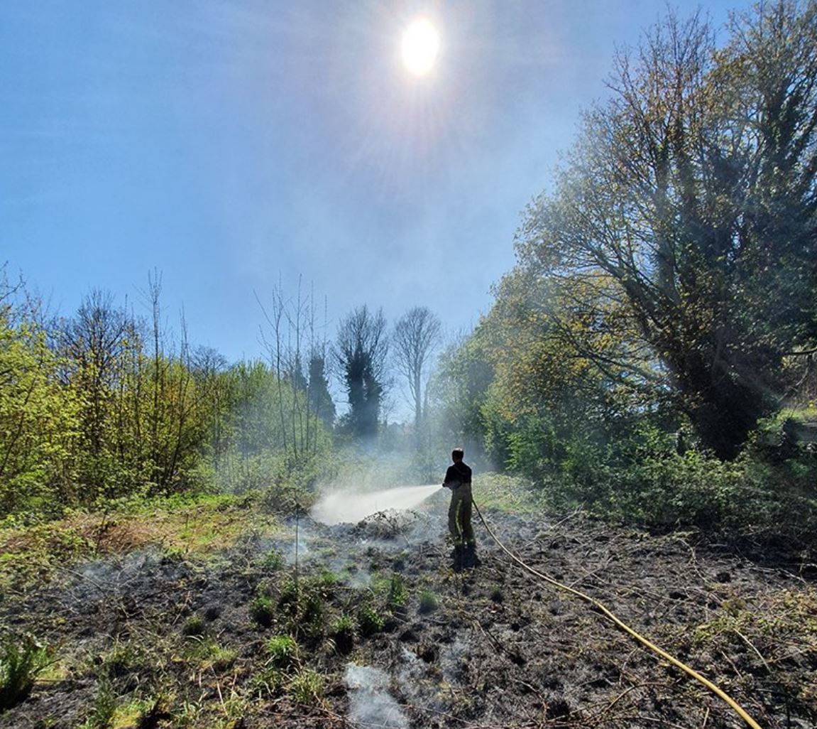 Firefighter tackling a garden fire. 