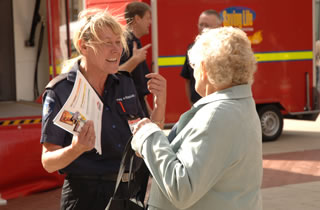 Firefighter talking with a member of the public.