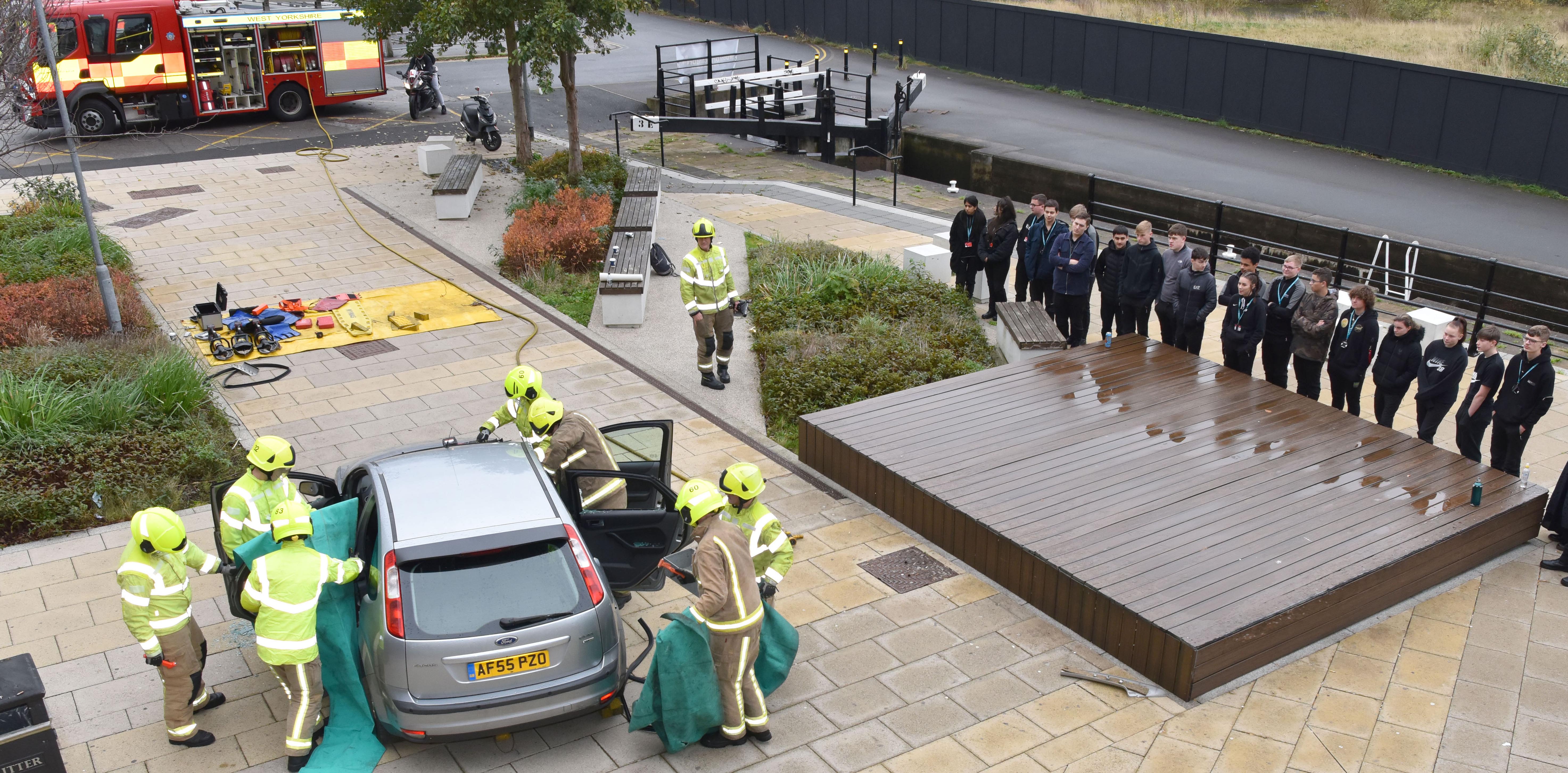 Photograph of students of Kirklees College watching a road traffic accident demonstration during road safety week 2021.