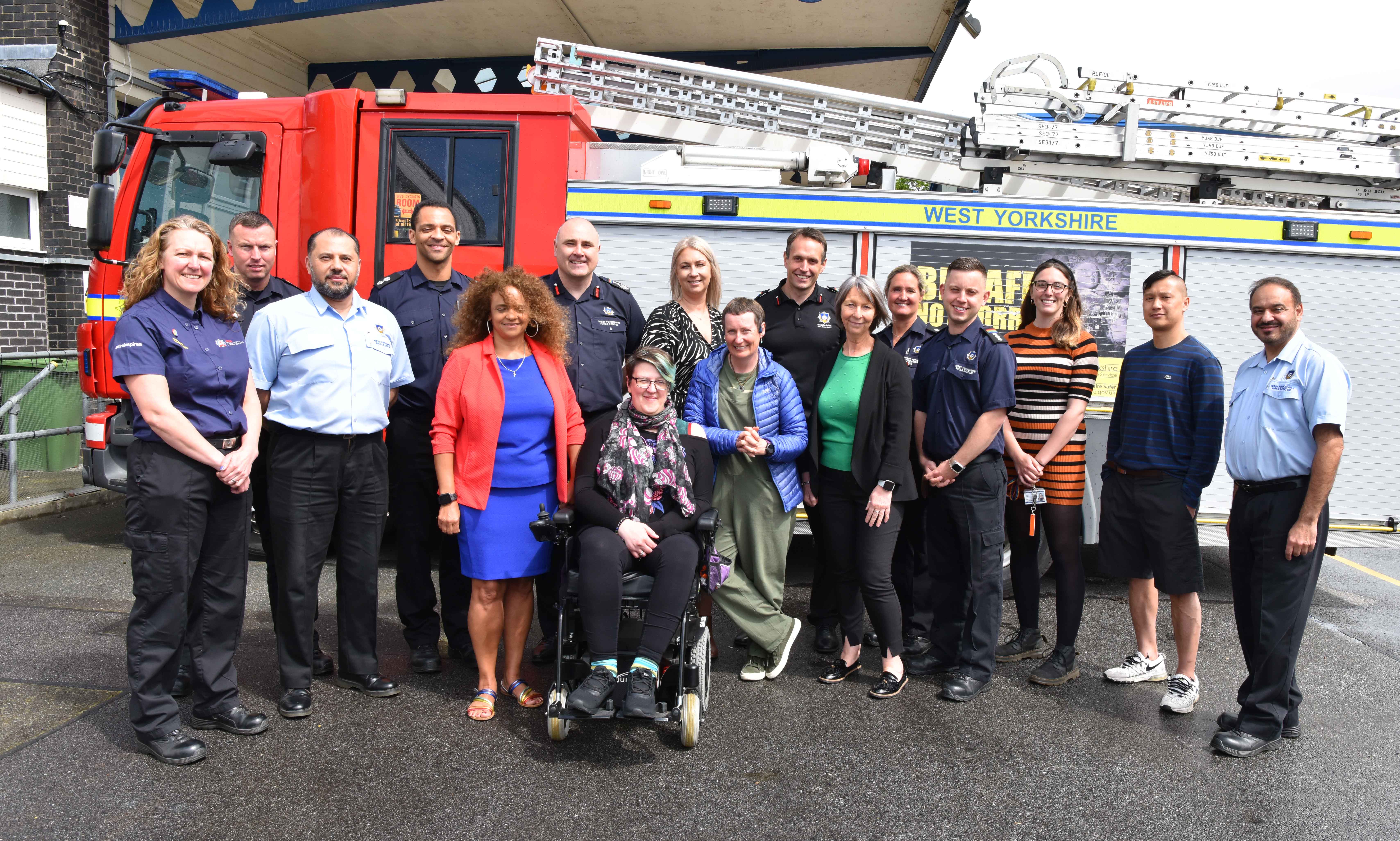 Photograph of staff in front of an appliance.