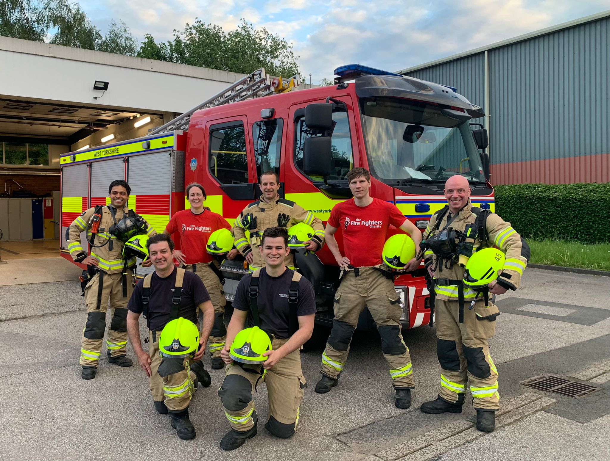 Crew infront of fire engine in kit and fire fighters charity t-shirts