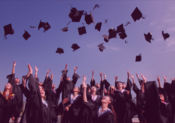 group of graduates throwing gaps in the air