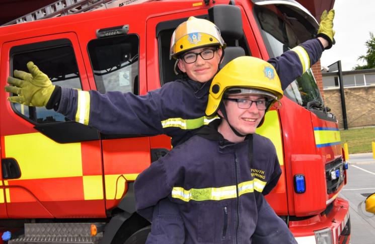 Two youth intervention team members smiling at the camera. 