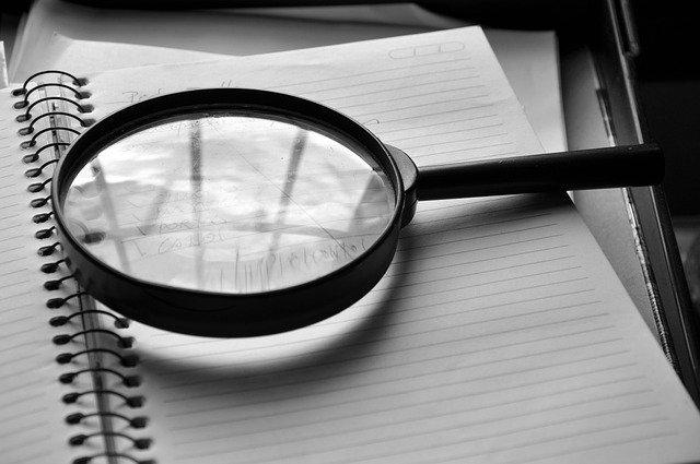 Magnifying glass on paper.
