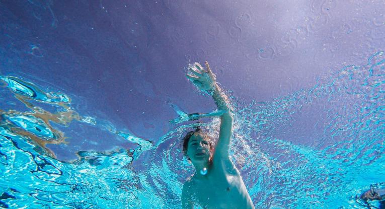 Child swimming in water. 