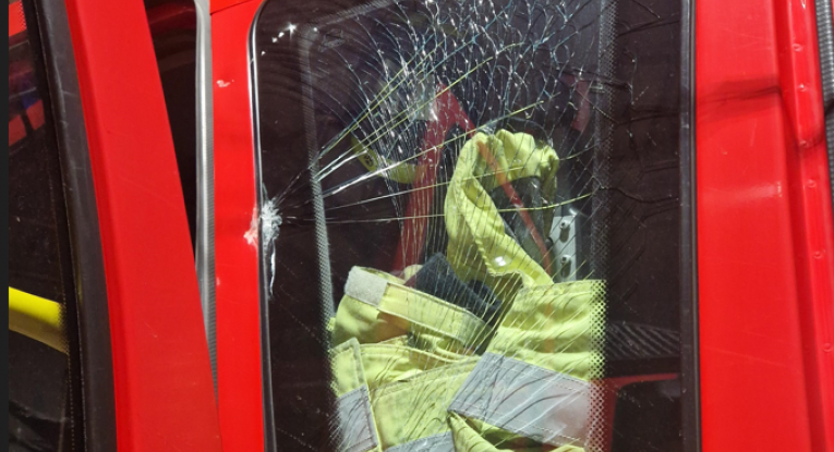 Window of fire engine smashed during an attack