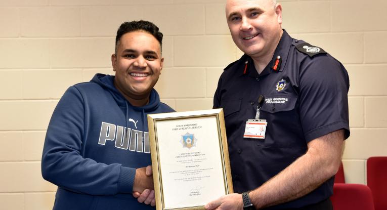 Masoom Miah with chief fire officer John Roberts